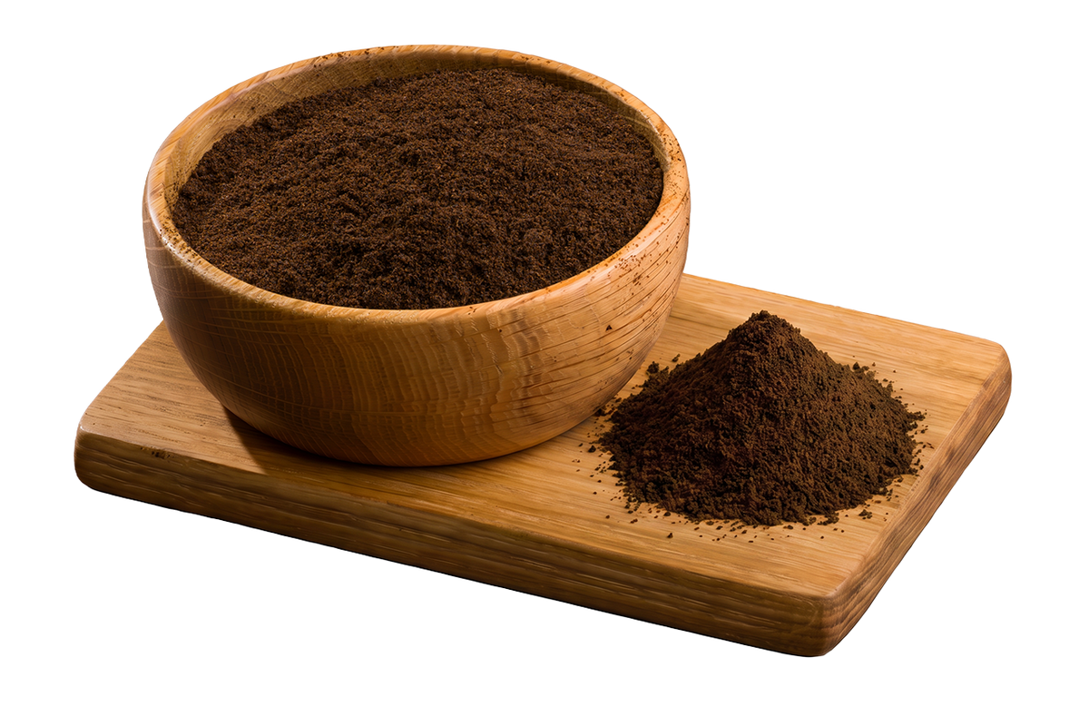 Madagascar Bourbon Grade B vanilla powder in a wooden bowl with a pile of finely ground vanilla powder on a wooden board.