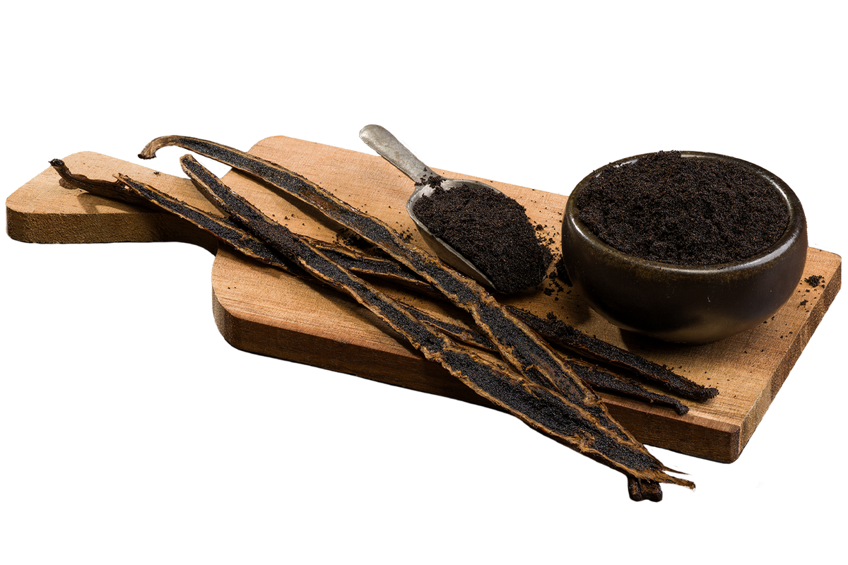 Madagascar Bourbon vanilla caviar in a bowl and spoon, surrounded by split vanilla beans on a wooden board.